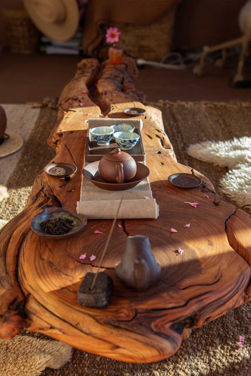 Tea set on a wooden table with a rustic background